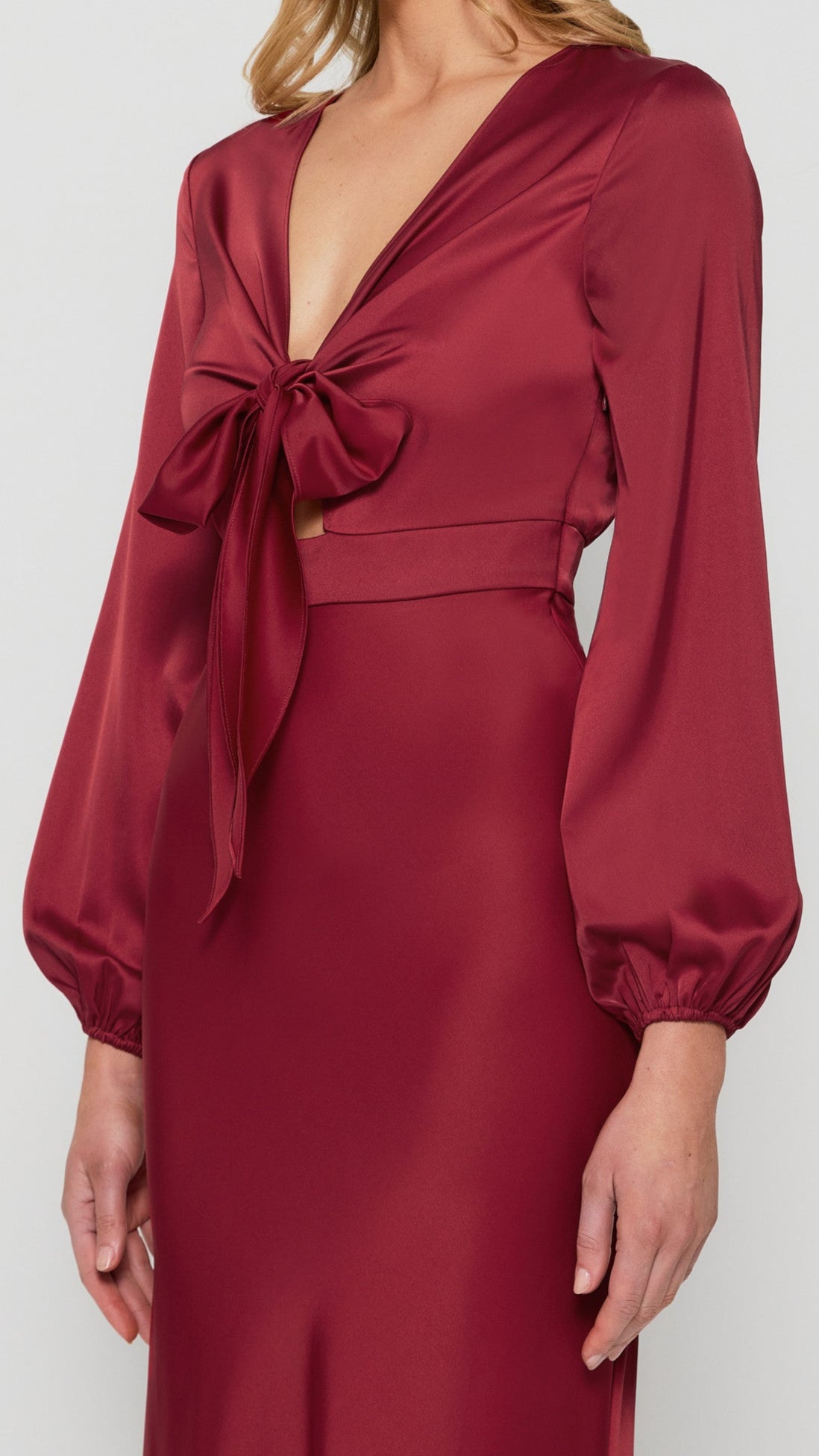 Close-up of satin fabric and front tie detail on dress