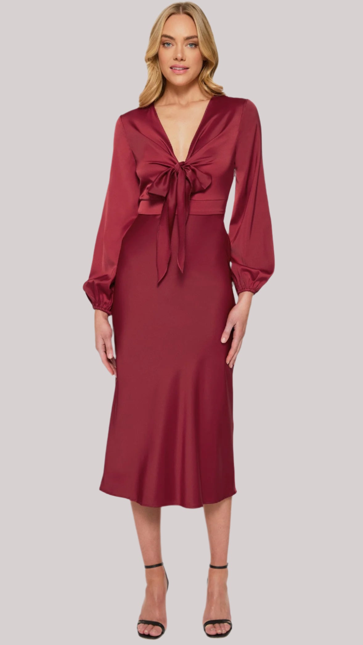 Model wearing wine-coloured satin midi dress with front tie and long sleeves