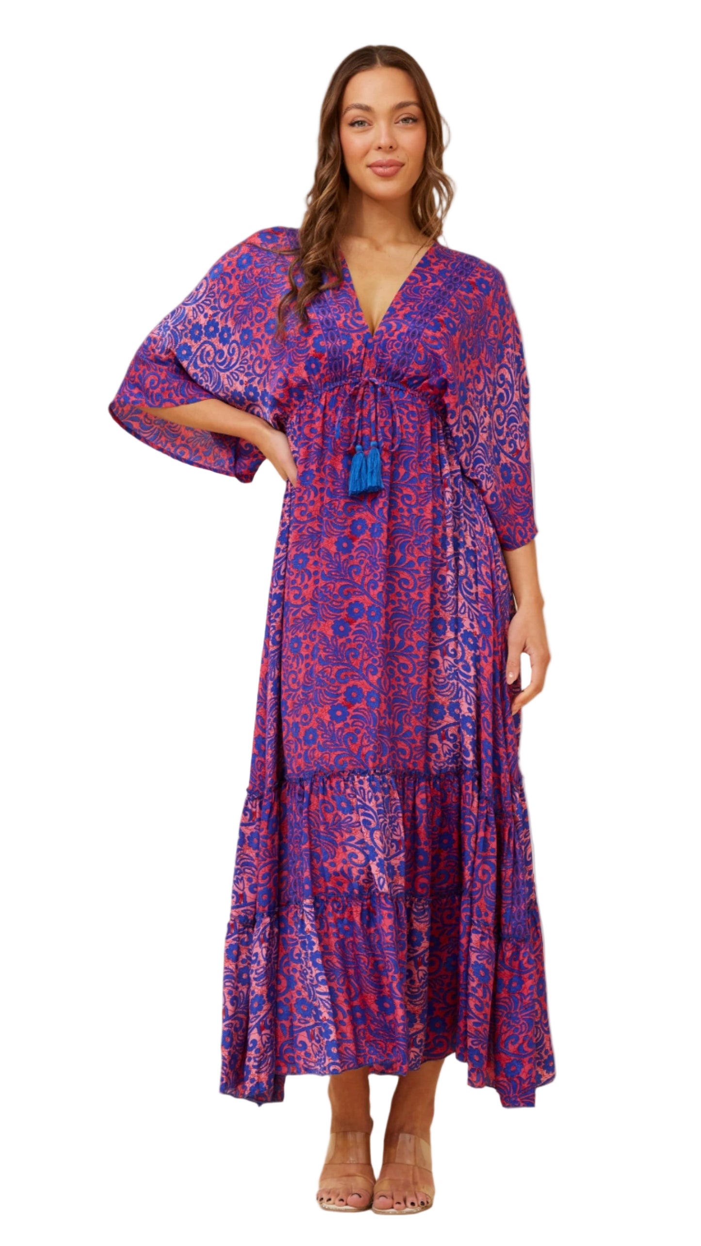 The Dreamweaver Maxi dress in vibrant pink and blue, worn front-facing with tiered hem and tassel neckline.
