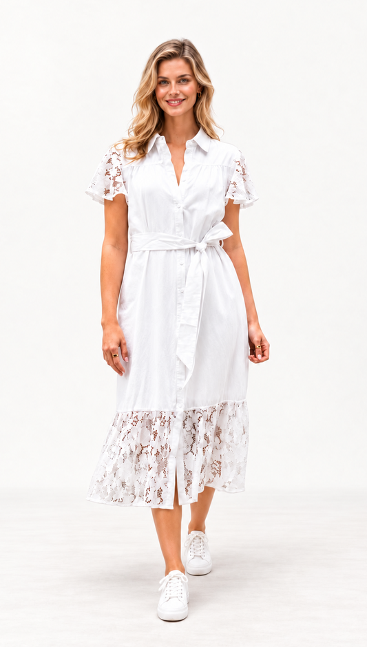 A woman modeling a white midi shirt dress with short lace flutter sleeves, a tie waist, and a lace hem, paired with white sneakers, against a plain white studio background.