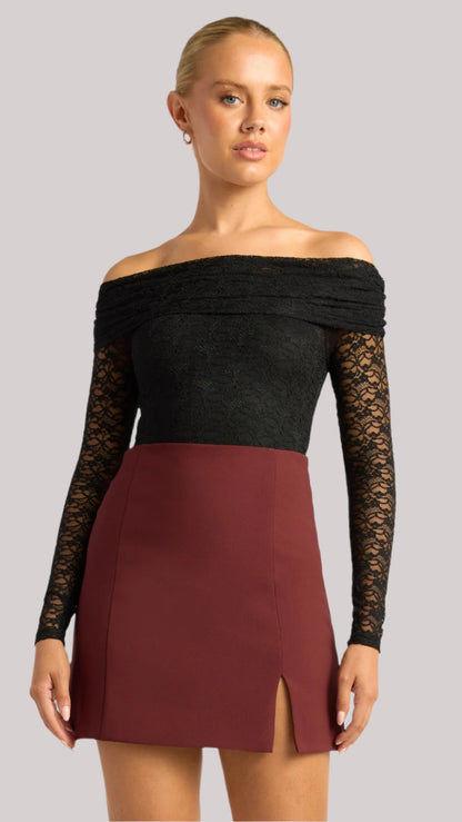 Model styled in the Amara Lace Bodysuit with a mini skirt – elegant and fitted look.
