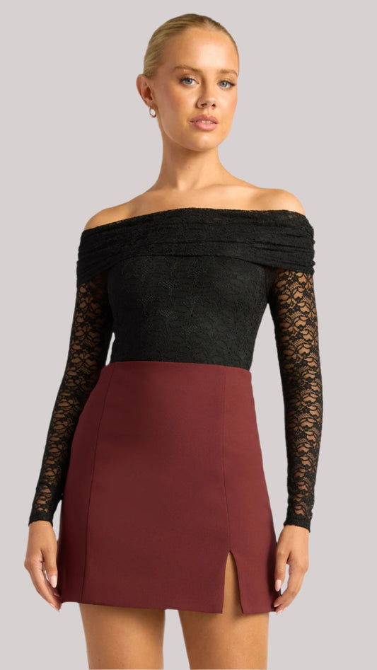 Model styled in the Amara Lace Bodysuit with a mini skirt – elegant and fitted look.