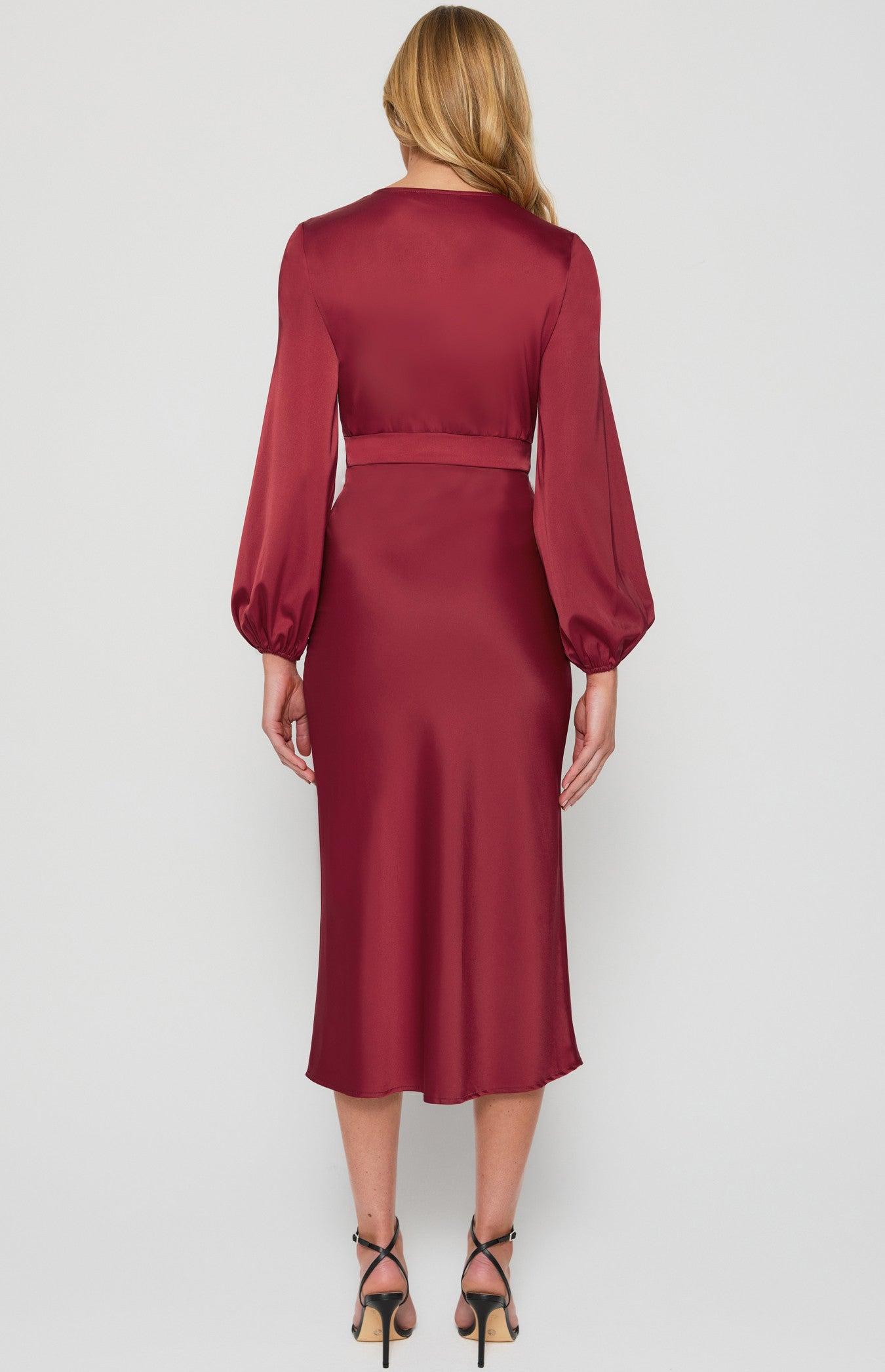 Back view of wine satin midi dress showing waist panel and sleeve detail