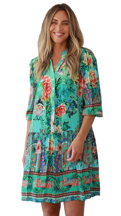 Woman wearing a colorful floral dress on a white background