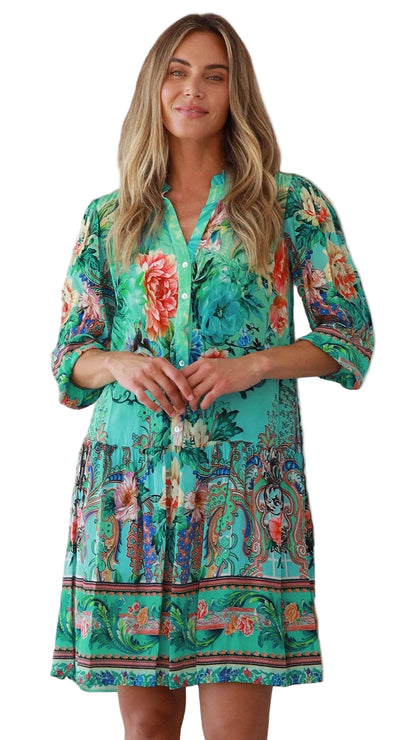 Woman wearing a colorful floral dress on a white background