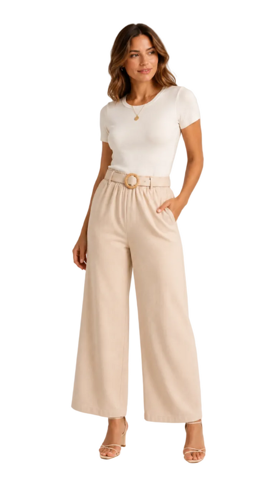 Woman wearing a white top and beige wide-leg pants on a plain background