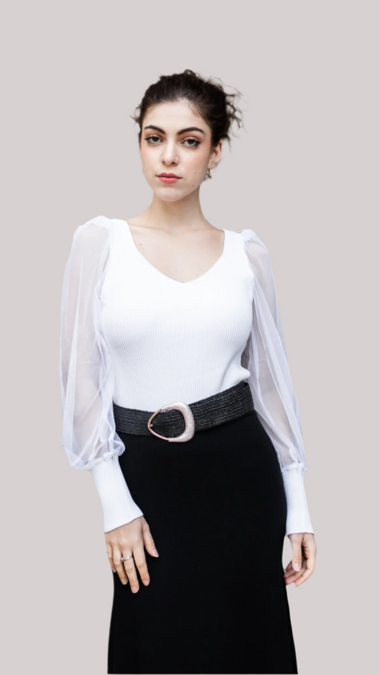 Woman wearing The Celeste Top with sheer sleeves and black skirt