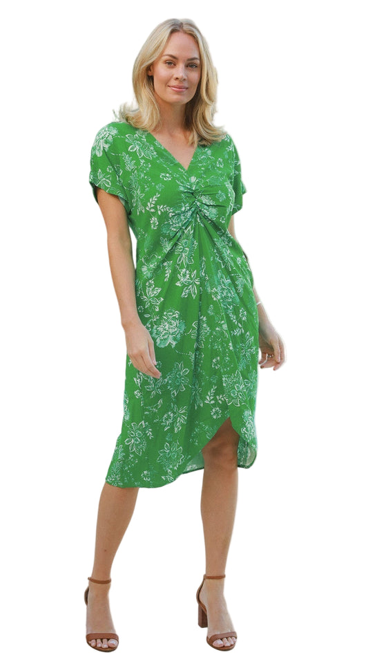 Woman wearing a green floral dress on a white background