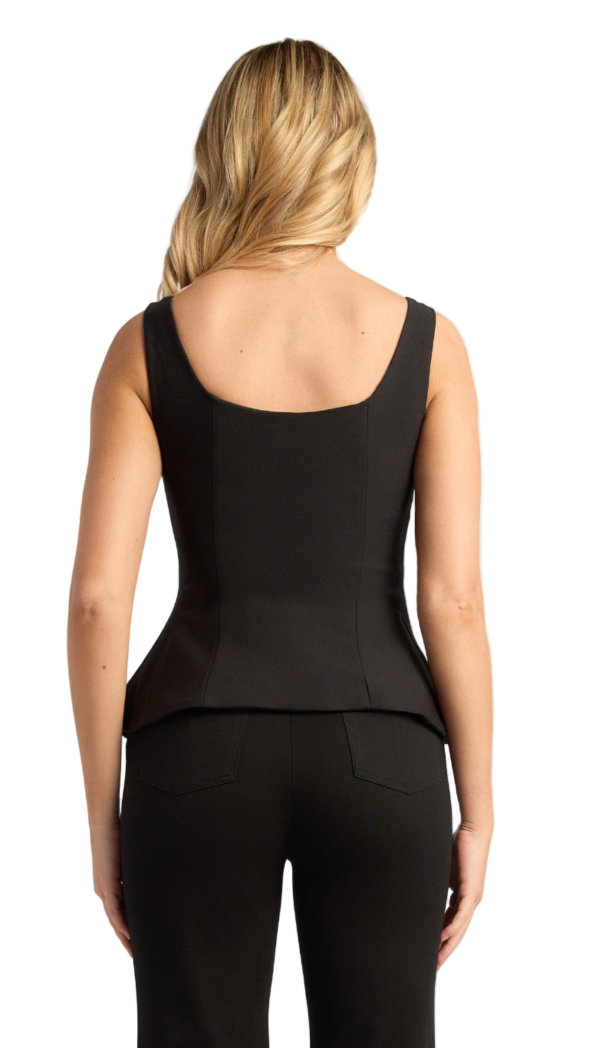 Person wearing a black sleeveless peplum top and pants on a plain background
