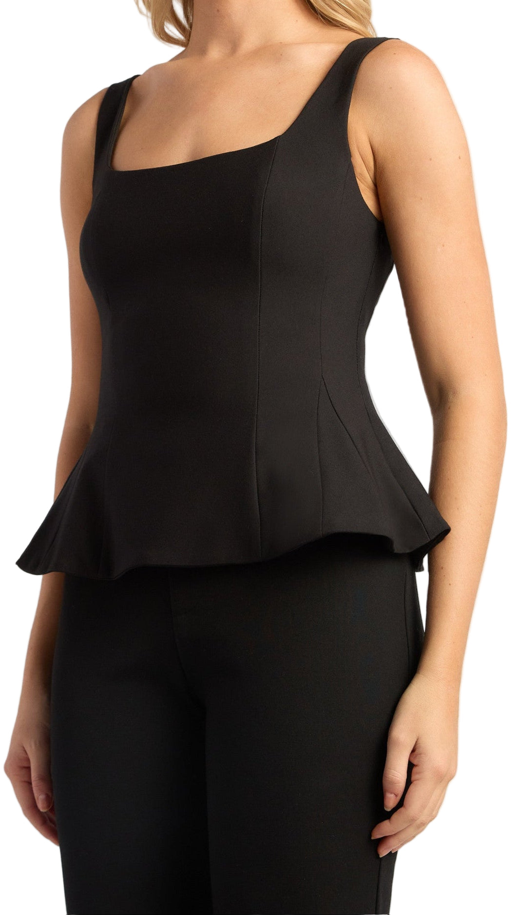 Black peplum top worn by a person on a white background