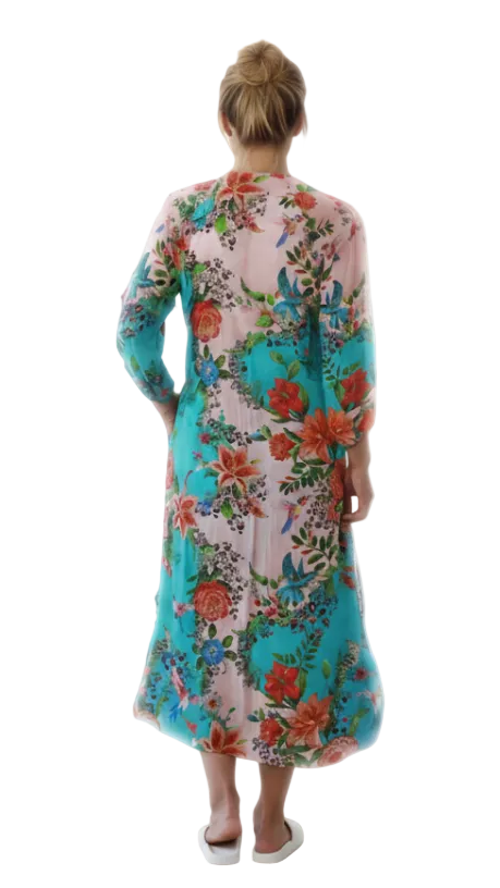 Back view of  Woman wearing a colorful floral dress on a white background
