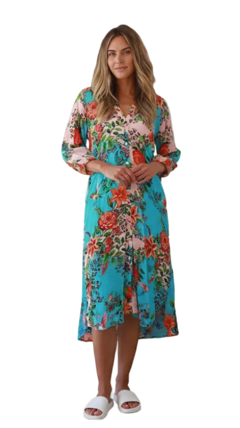 Woman wearing a colorful floral viscose crepe dress on a white background