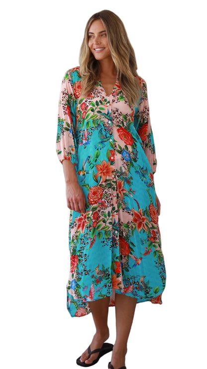 Woman wearing a colorful floral dress on a white background