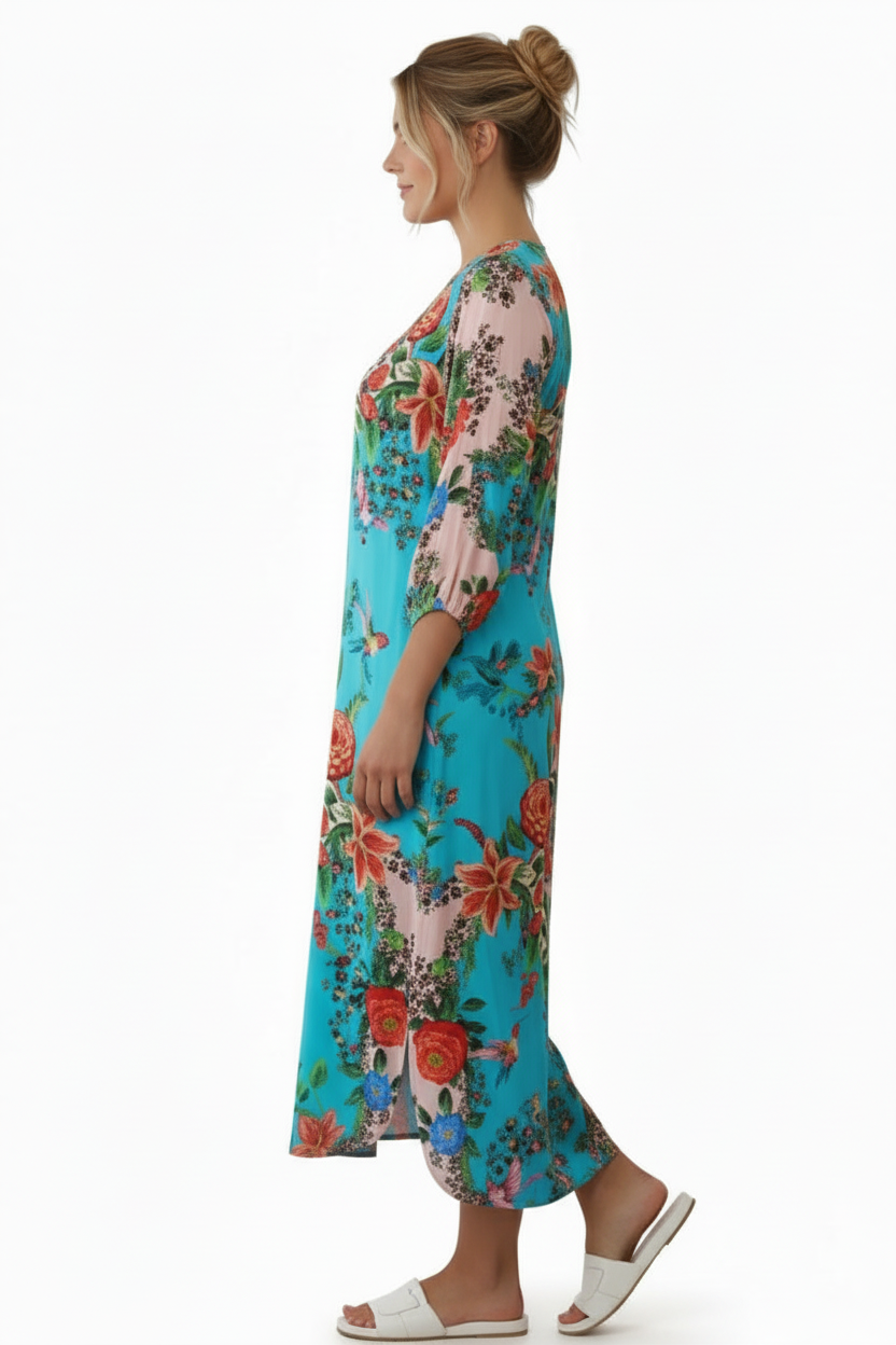 Side view of Woman wearing a colorful floral dress on a white background with hair up