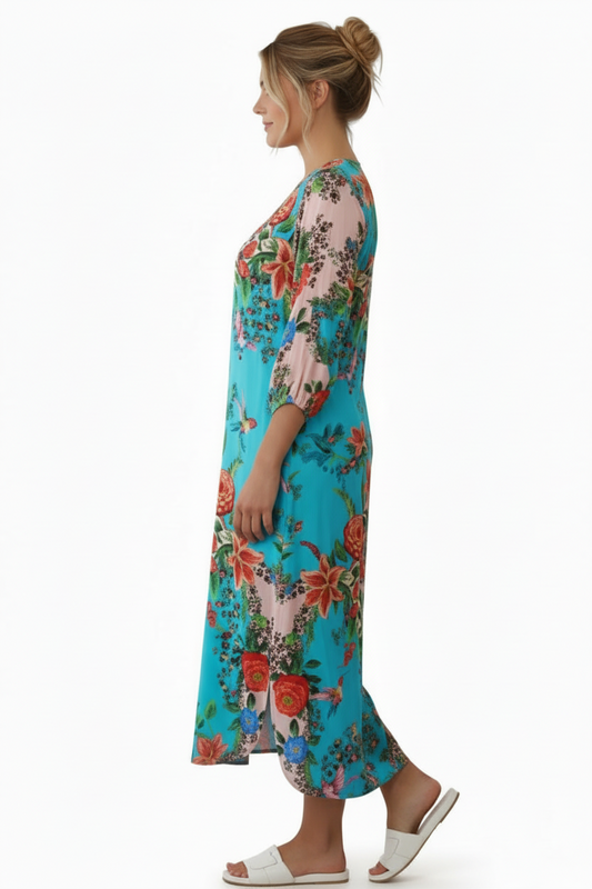 Side view of Woman wearing a colorful floral dress on a white background with hair up