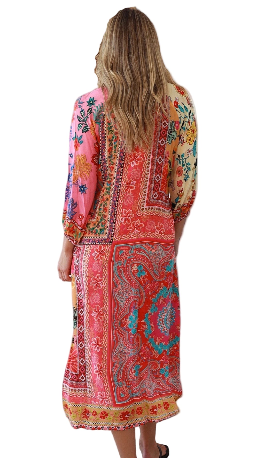 Woman wearing a colorful patterned dress on a white background