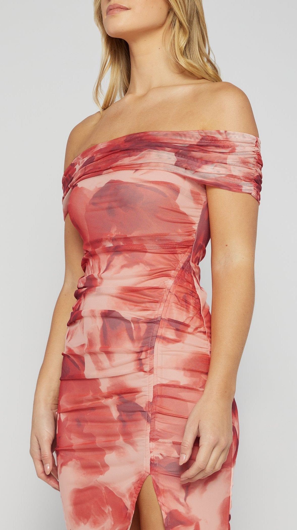 View of the Rose Allure Dress highlighting the off-shoulder neckline, body ruching  and thigh split.