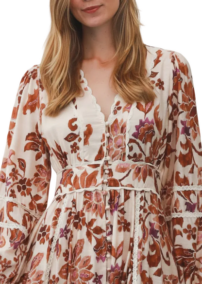 Close up of Woman wearing a floral dress with long sleeves on a white background