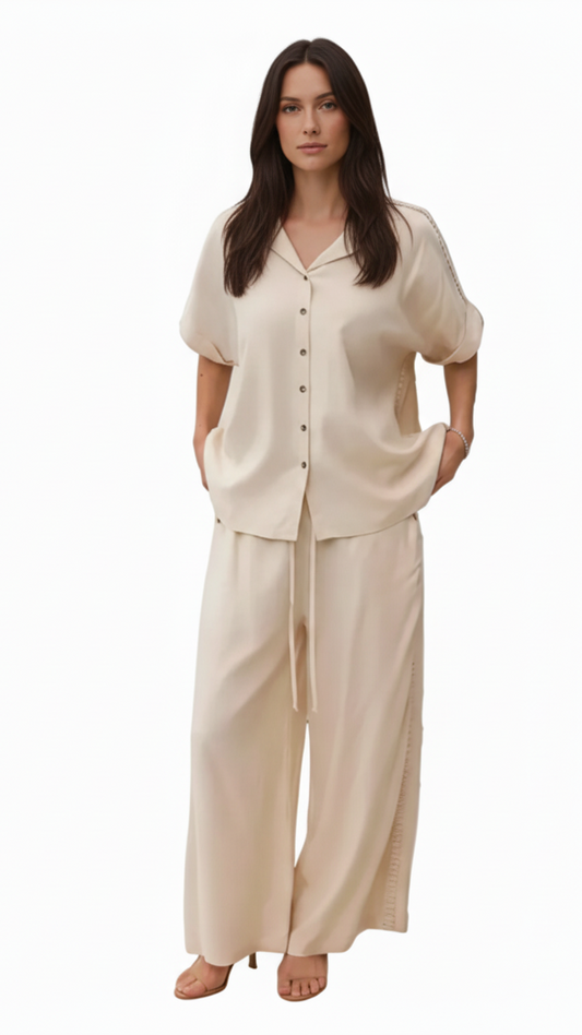 Full length view of model wearing beige linen blend button through top