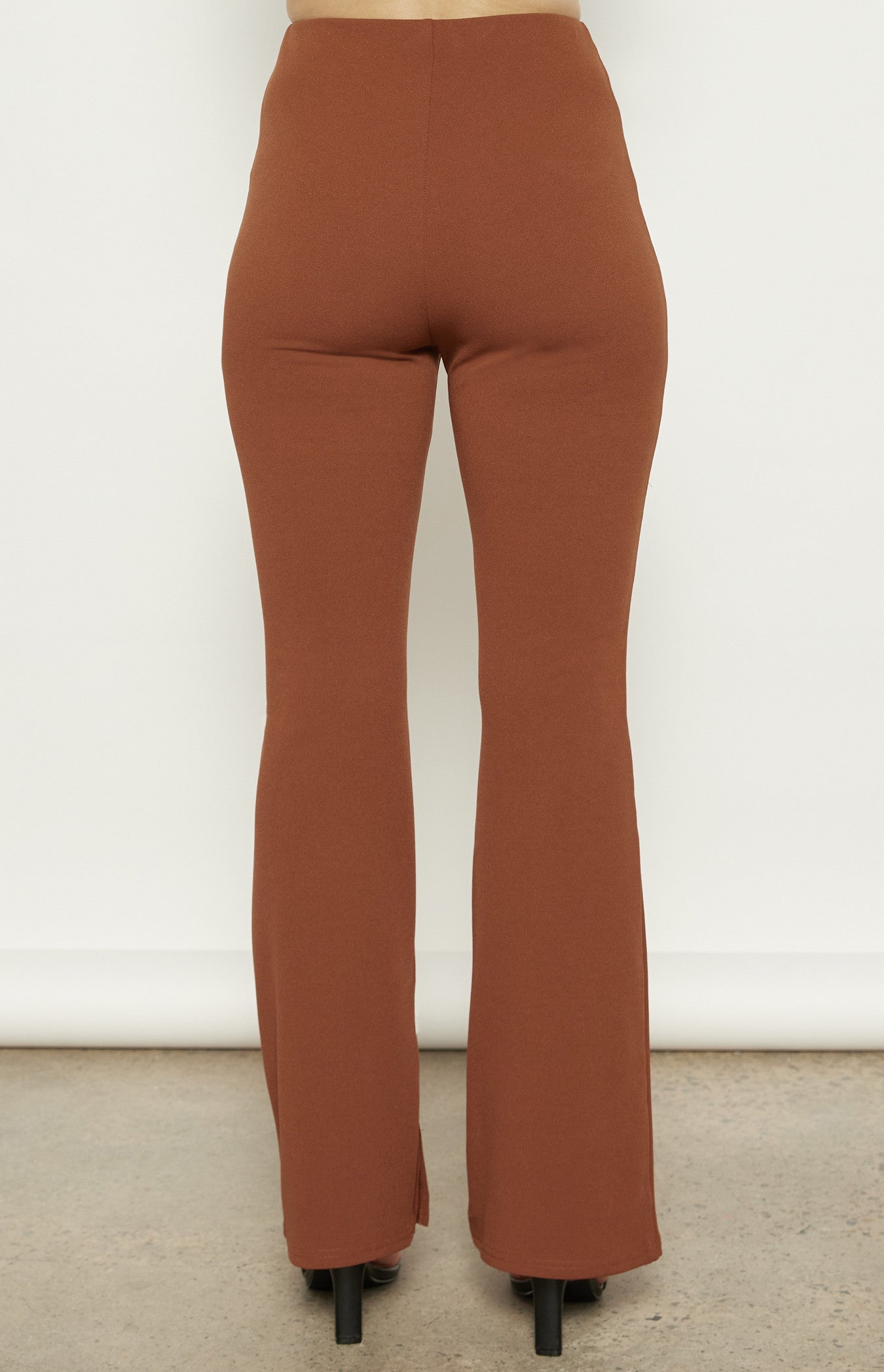Back view of the Terra Flare Pants, showing the smooth, fitted waistline and relaxed flare shape.