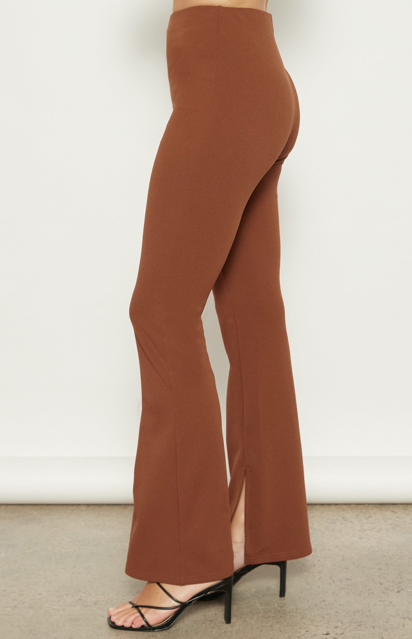 Close-up of the Terra Flare Pants from the side, emphasizing the high-waisted fit and stretchy jersey fabric.