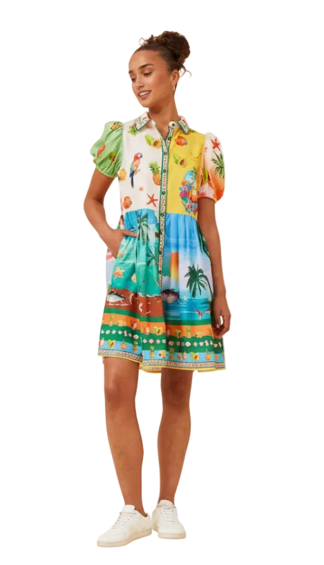 Woman wearing a colorful patterned dress on a white background