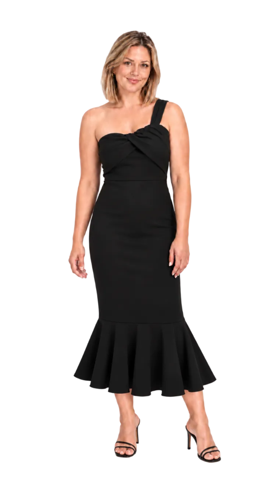 A woman modeling a black one-shoulder midi dress with a twisted neckline and a flared ruffled hem, paired with black strappy heels, against a plain white studio background.