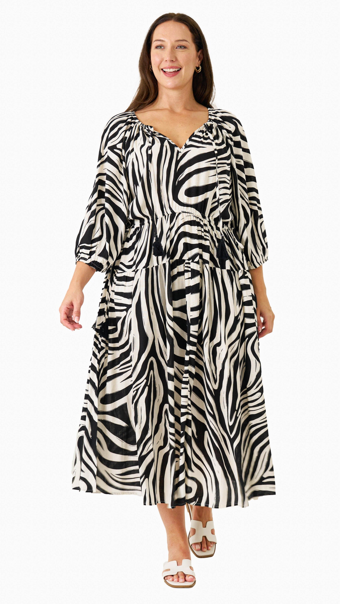 Zeeba Midi Dress in chocolate shown walking front-on with puff sleeves and flowing skirt.