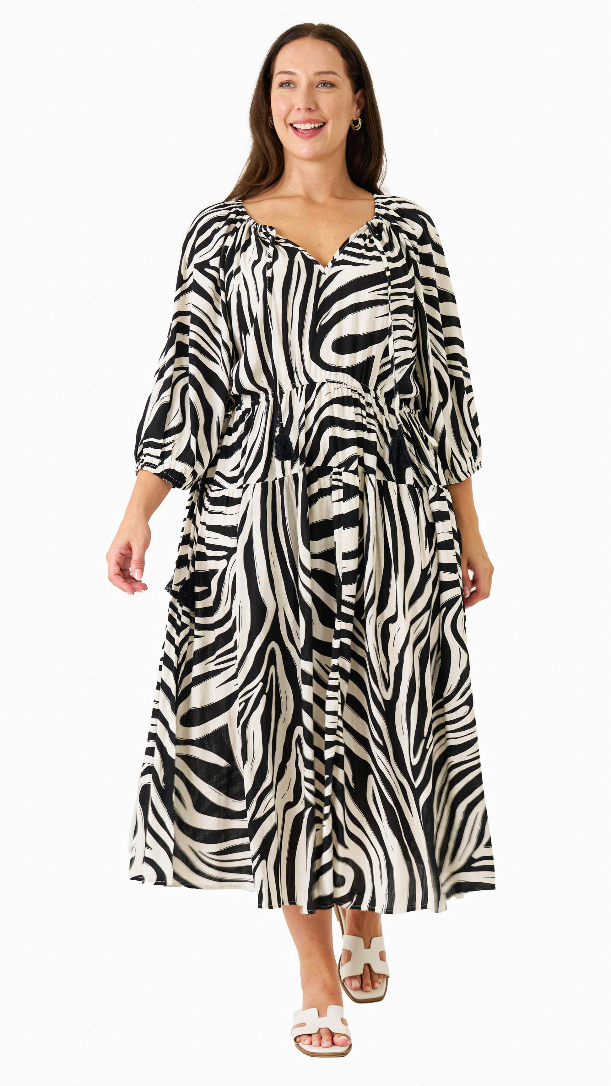 Zeeba Midi Dress in chocolate shown walking front-on with puff sleeves and flowing skirt.