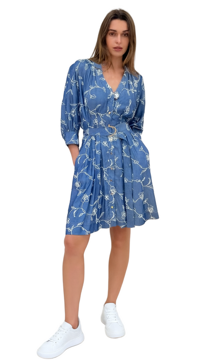 Woman wearing a blue floral dress on a white background