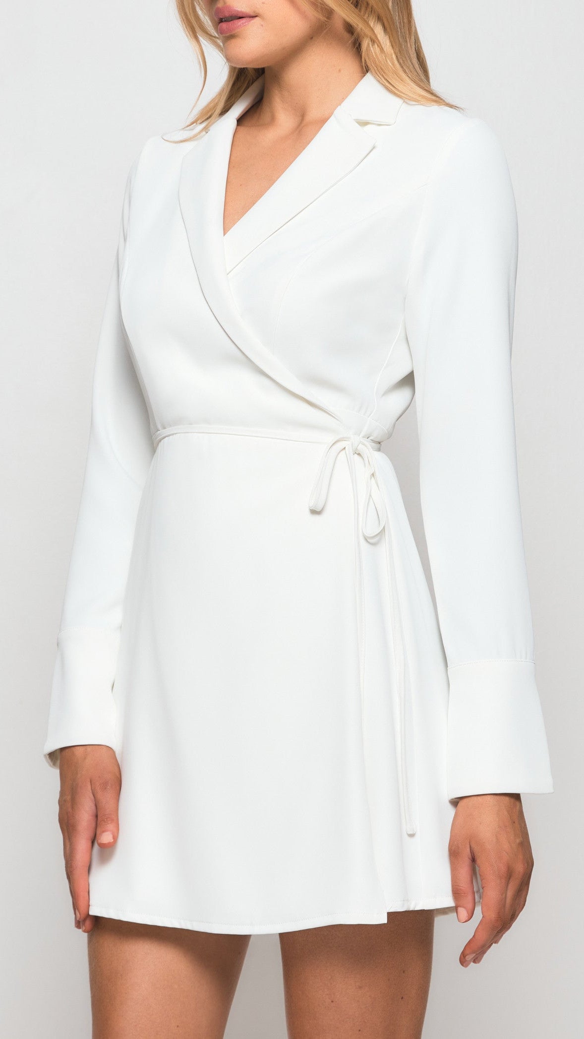 White wrap dress worn by a model on a plain background